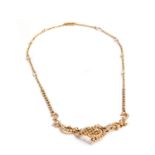 A VICTORIAN SEED PEARL NECKLACE centred by two inverted C-scrolls joined by lattice work and a