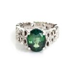 A GREEN SAPPHIRE, DIAMOND AND PLATINUM RING, ANPA the claw-set oval mixed-cut slightly bluish-