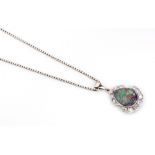 A BLACK OPAL AND DIAMOND PENDANT the tube-set pear-shaped opal surrounded by 12 pavé-set round