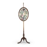 A VICTORIAN POLE FIRE SCREEN the oval form needlework depicting flowers and foliage on turned