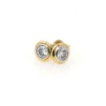 A PAIR OF DIAMOND EARRINGS bezel set with a pair of round brilliant cut diamonds weighing 0,36