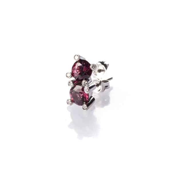 A PAIR OF GARNET AND DIAMOND EARRINGS claw-set to the centre with two round brilliant-cut