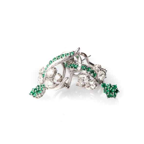 A PAIR OF TSAVORITE AND DIAMOND EARRINGS set in an intricate floral design with round brilliant-