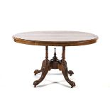 A MAHOGANY WINE TABLE, 19TH CENTURY the circular top on a turned, tapering column, on three hipped