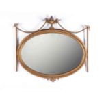 A GILDED OVERMANTEL MIRROR, 19TH CENTURY the oval bevelled plate within a moulded conforming frame