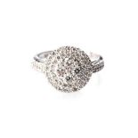 A DIAMOND RING a cluster of diamonds pavé-set along upper edge and down either side, a combined