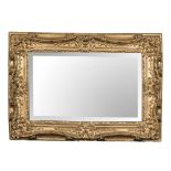 A GILDED MIRROR the rectangular bevelled plate within a moulded gold frame 61cm high, 76cm wide