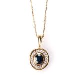 A SAPPHIRE AND DIAMOND PENDANT bezel-set to the centre in 18ct yellow gold, an oval sapphire