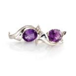 A PAIR OF AMETHYST AND DIAMOND EARINGS Each of ribbon and leaf design, claw set with an oval mixed-