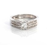 A DIAMOND RING Claw set to the centre with a round brilliant cut diamond weighing approximately 0.