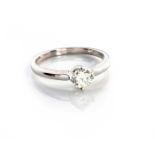 A DIAMOND RING Claw set with a round brilliant cut diamond weighting approximately 0.30ct, in