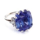 A TANZANITE AND DIAMOND RING The claw set radiant cut tanzanite weighing approximately 18ct