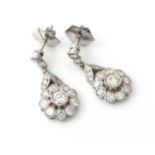 A PAIR OF DIAMOND DROP EARRINGS Designed as a stylised flower, millegrain collet set throughout on a