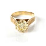 A DIAMOND RING Set with a round brilliant-cut fancy yellow diamond weighing approximately 2,7ct,