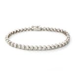 A DIAMOND TENNIS BRACELET Tube set with forty-four round brilliant cut diamonds weighing