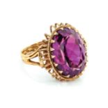 AN AMETHYST RING Claw set to the centre with an oval faceted amethyst weighing approximately 7.