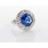 A SAPPHIRE AND DIAMOND RING The claw set brilliant cut sapphire weighing approximately 6ct