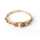 A 14ct SAPPHIRE AND PEARL BANGLE the hinged open-work frame claw-set with sapphires and