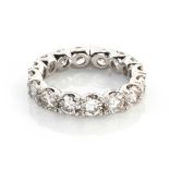 A DIAMOND ETERNITY RING Claw set sixteen round brilliant cut diamonds weighing approximately 3,5ct