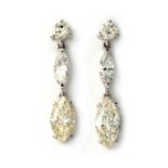 A PAIR OF DIAMOND EARRINGS Each claw set marquise cut diamond suspending two graduating claw set