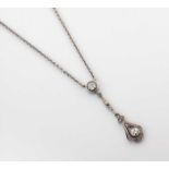 A DIAMOND PENDANT NECKLACE Collet and millegrain set with an old-cut diamond surrounded by