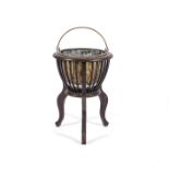 A BRASS POT AND MAHOGANY STAND, 19TH CENTURY Wooden tripod stand enclosing a brass pot,53cm high,