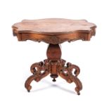 A VICTORIAN MAHOGANY LOO TABLE The serpentine shaped top above a carved frieze, faceted baluster