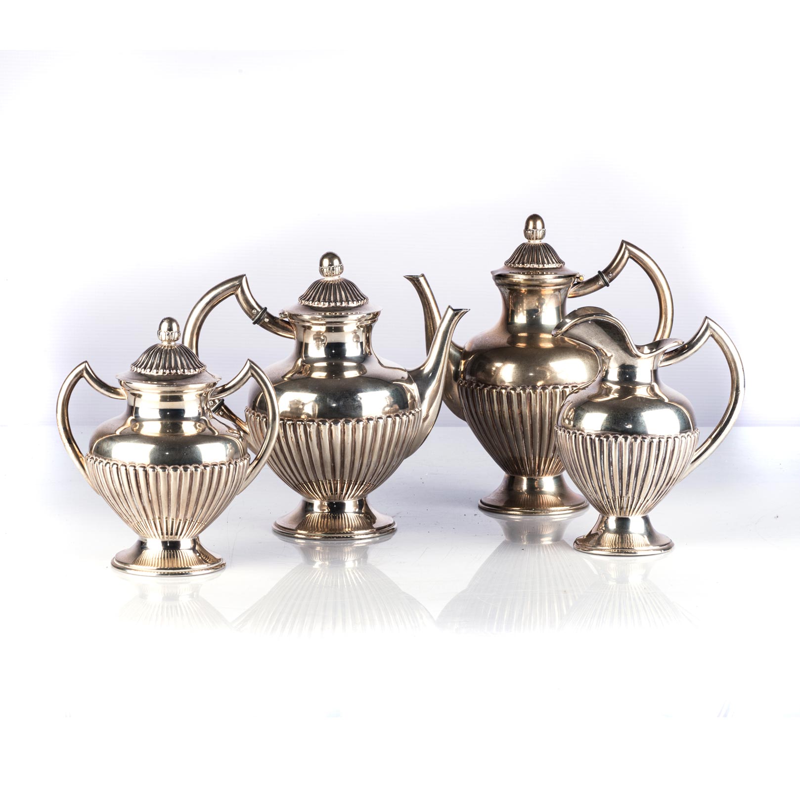 A PORTUGUESE ASSEMBLED SILVER TEA SET, PORTUGAL, 1938 Comprising: one large teapot, one smaller