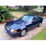 A 1992 MERCEDES-BENZ 300SL24V Floor shift automatic roadster finished in midnight blue with grey