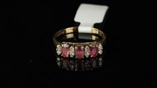 Ruby and diamond half hoop, three oval cut rubies, each separated by two single cut diamonds, ring