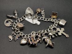 Silver charm bracelet, curb link with an engraved heart padlock clasp, with safety chain, plus