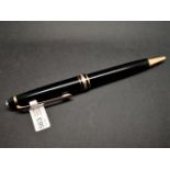 Mont Blanc black lacquer and yellow metal ballpoint pen, currently working.