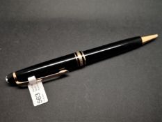 Mont Blanc black lacquer and yellow metal ballpoint pen, currently working.
