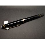 Mont Blanc black lacquer and yellow metal ballpoint pen, needs refill.