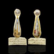 Pair of painted landmark scenes on ivory, two round small scenes with a long pear shaped drop,