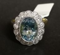 Aquamarine and diamond cluster ring, central oval cut aquamarine, surrounded by round brilliant