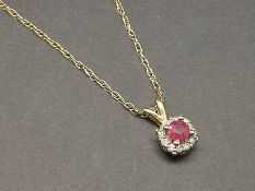 Ruby and diamond pendant, central round cut ruby, surrounded by round brilliant cut diamonds,