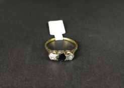 Three stone sapphire and diamond ring, central round sapphire, with an illusion set diamond each