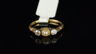 Three stone pearl and diamond ring, central pearl measuring 5.1 x 4.2mm, with an old cut diamond set
