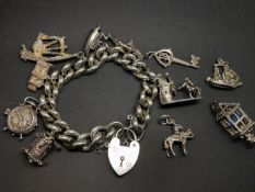 Silver charm bracelet, set with six charms and four loose charms, gross weight approximately 91.2