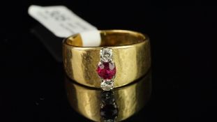 A ruby and diamond dress ring, with a central round mixed cut ruby measuring approximately 4.4mm,