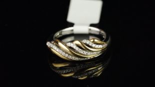 Diamond twist ring, three rows of round brilliant cut diamonds, interspaced with yellow metal