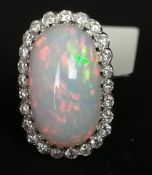 An opal and diamond ring, an oblong shaped cabochon cut opal measuring approximately 17.10 x 10.5mm,