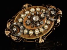 A Victorian pearl and diamond brooch, central old cut diamond, surrounded by two further old cut