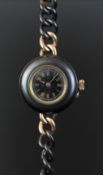 GENTLEMEN'S FOB/WRISTWATCH, BLACK AND GOLD TONE, FLO 1888 CASEBACK, circular black gilt dial with