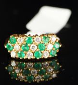 An emerald and diamond ring, designed as alternating diagonal rows, mounted in 18ct yellow gold,