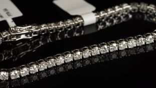 A diamond tennis bracelet, forty-eight round brilliant cut diamonds, weighing an estimated total