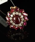 Ruby and diamond pendant, central oval cabochon cut ruby measuring an estimated 9mm, surrounded by
