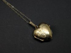 9ct yellow gold heart locket, with engraved detail to the front, on a fine yellow metal chain