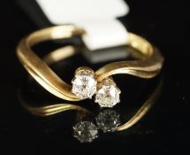 Two stone diamond crossover ring, mounted in yellow metal stamped 18ct, two round old cut diamonds